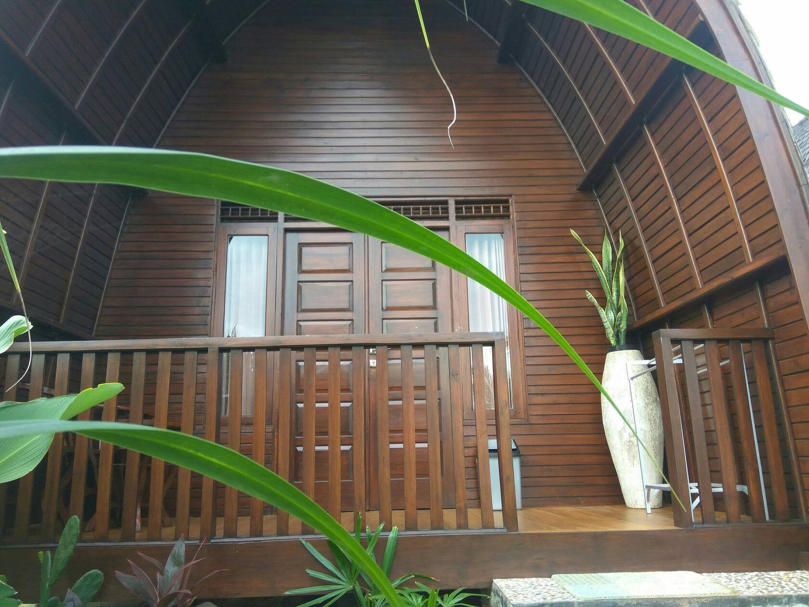 Bungalow front with wooden veranda