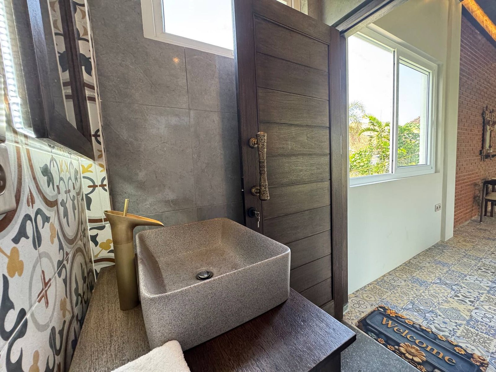 Bathroom with stone basin and brass tap