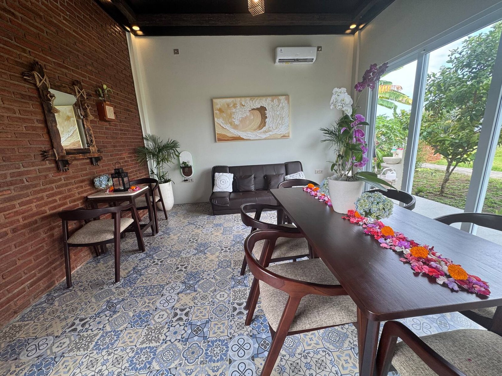 Living and dining room with tiled floor and garden view